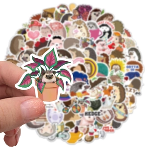 Close-up of a cartoon hedgehog sticker in a pink potted plant with a blurred background