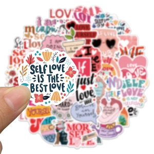 Close-up of waterproof self-love stickers with inspirational quotes and floral illustrations