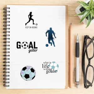 Waterproof football stickers with motivational quotes on a spiral notebook desk setup