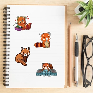 Flat lay of red panda stickers on a white notebook with stationery on a wooden desk