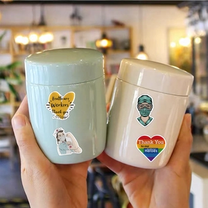 Macro view of waterproof healthcare hero stickers applied on smooth ceramic storage jars