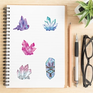 Macro shot of colorful Bohemian crystal stickers and lavender design on a notebook