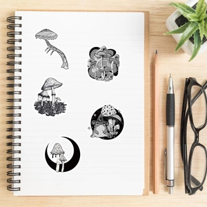 Detail of gothic black and white mushroom stickers on a white spiral notebook