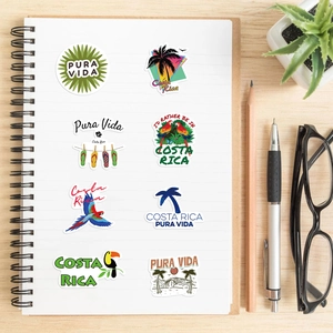 Detail of Costa Rica Pura Vida stickers displayed on a notebook over a wooden desk