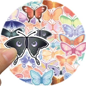 Close-up of waterproof butterfly stickers with celestial moon and star patterns