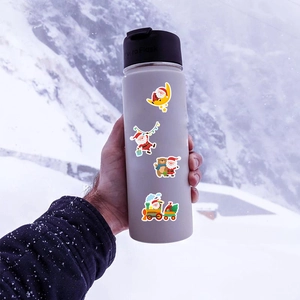 Waterproof cartoon Santa Claus stickers displayed on a water bottle with snow background