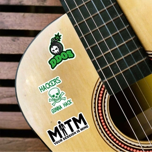 Three hacker-themed waterproof vinyl stickers displayed on a classic wooden guitar body