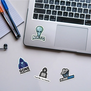 Close-up of waterproof hacker and geek stickers on a laptop surface for decoration