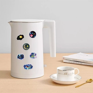 Detail of waterproof galaxy stickers applied on a kettle with various moon patterns