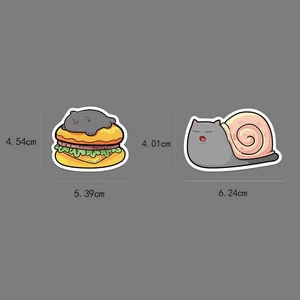 Detail showing hand-drawn cat stickers featuring cat-burger and snail-cat with size dimensions