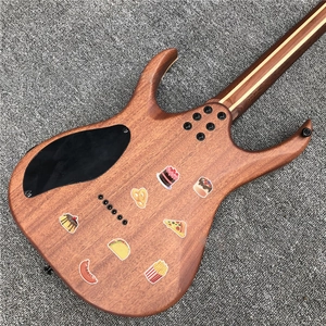 Macro detail of natural wood grain electric guitar back with food theme graffiti stickers