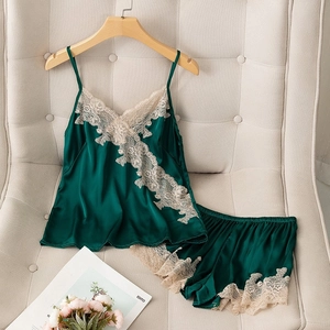 Elegant dark green silk satin pajamas set with lace trim camisole and matching shorts