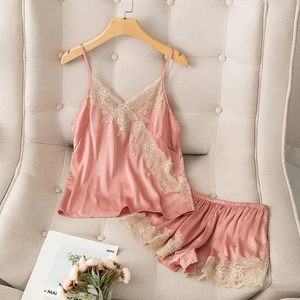 Detail of pink satin camisole set with intricate floral lace trim and elastic waistband