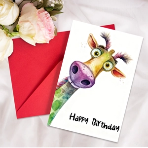 Detail of watercolor giraffe birthday card with a red envelope on white fabric background