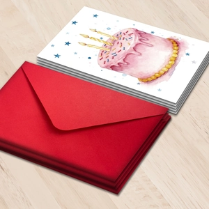 Large birthday card set with watercolor cake illustration and red envelopes on wood