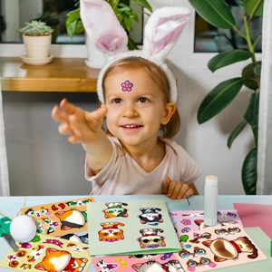 Girl playing with colorful cartoon cat sticker set for creative DIY crafts