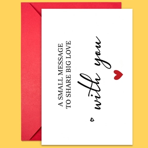 Close-up of greeting card with text A SMALL MESSAGE TO SHARE BIG LOVE and red envelope