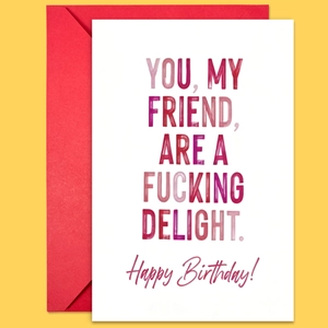 Close-up of creative birthday card with modern typography and vibrant red envelope