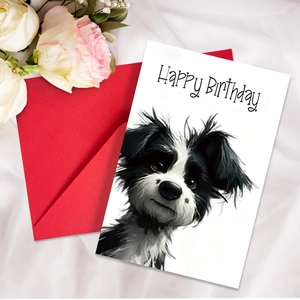 Cute puppy birthday card with Happy Birthday text and red envelope on white silk