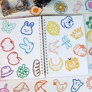Set of 56 colorful cartoon PET stickers on a grid notebook with decorative vintage props