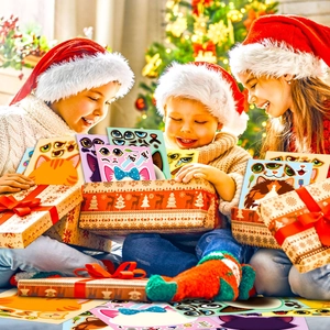 Three children in Christmas hats showing a gift box with cat DIY face puzzle stickers