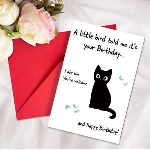 Funny birthday card with black cat illustration and red envelope on white fabric background