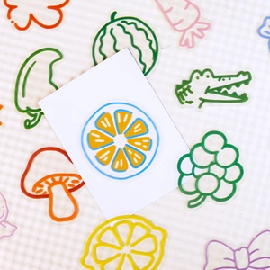 Detailed view of colorful cartoon PET stickers with lemon and mushroom designs on white card