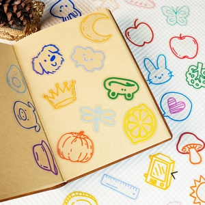 Detail of cute colorful PET transparent stickers featuring cartoon dogs and moons on a notebook
