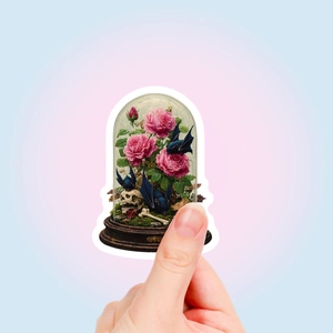 Detail shot of gothic floral stickers featuring pink roses, bats, and skulls on a hand