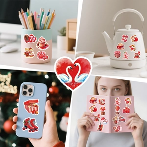 Close-up of romantic red heart stickers applied on phone case and diary for decoration