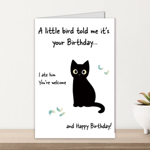 Close-up of minimalist birthday card with funny black cat illustration on wooden surface