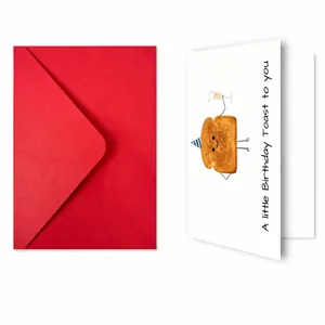 Detailed view of creative birthday card with funny toast illustration and red envelope