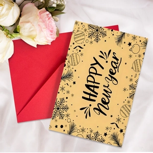 Flat lay of Happy New Year card with festive illustrations and red envelope on white fabric