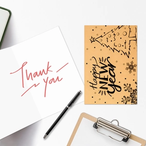 Flat lay of Happy New Year cards and Thank You envelopes with festive stationery layout