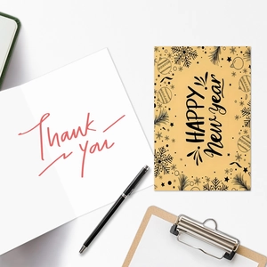 Close-up of festive greeting cards with HAPPY New Year and Thank You text prints