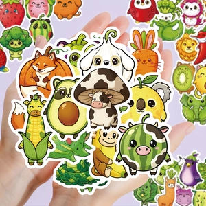 Close-up of cute animal and vegetable cartoon stickers held in hands for decoration