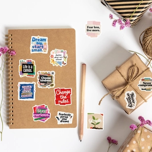 Flat lay of motivational English stickers on a kraft notebook with dried lavender decoration