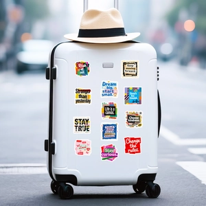 Detail of 12 creative graffiti stickers with motivational English quotes on a white suitcase