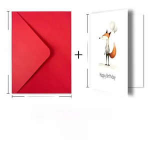 Close-up of birthday card set with fox illustration and red envelope on white background