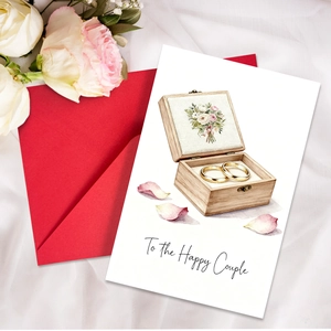 Detailed wedding card with watercolor ring box illustration and To the Happy Couple text
