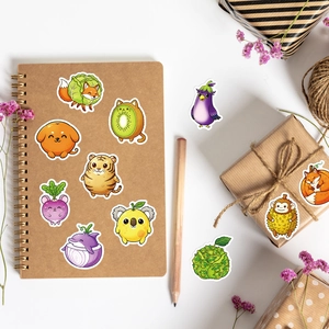 Flat lay of cute animal and fruit cartoon stickers on stationery and gift boxes