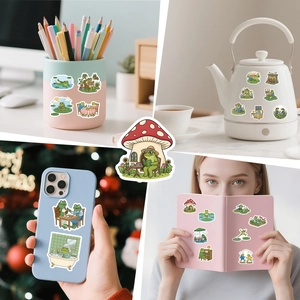 Cute frog stickers applied to pencil holder, water bottle, phone case, and notebook