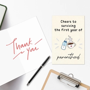 Close-up of First Year of Parenthood greeting card with coffee and baby bottle illustration