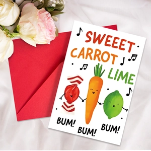 Close-up of creative vegetable cartoon greeting card with red envelope on white fabric