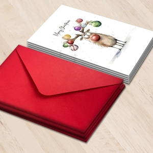 Christmas cards set with watercolor reindeer illustration and red envelopes on wood