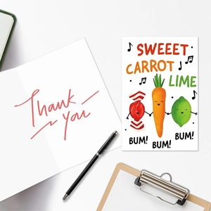 Close-up of creative cartoon carrot and lime greeting card with handwritten Thank You note