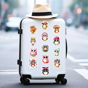 Pink owl stickers showing various cute cartoon designs on a white suitcase surface