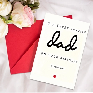 Close-up of birthday card for dad on red envelope with white roses and silk background