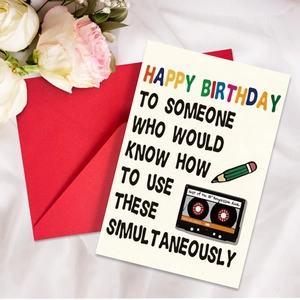 Close-up of humor birthday card with retro cassette illustration and bright red envelope
