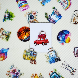 Close-up of travel themed stickers including red vintage car and scenic illustrations